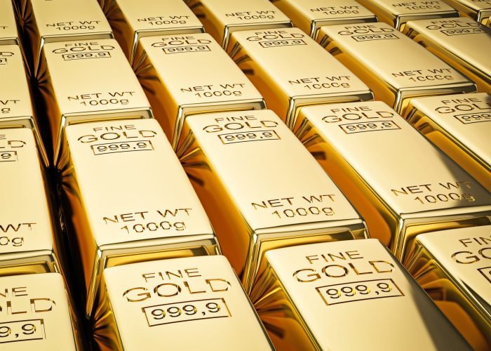 Banking finance concept background - stacks of gold bars close up